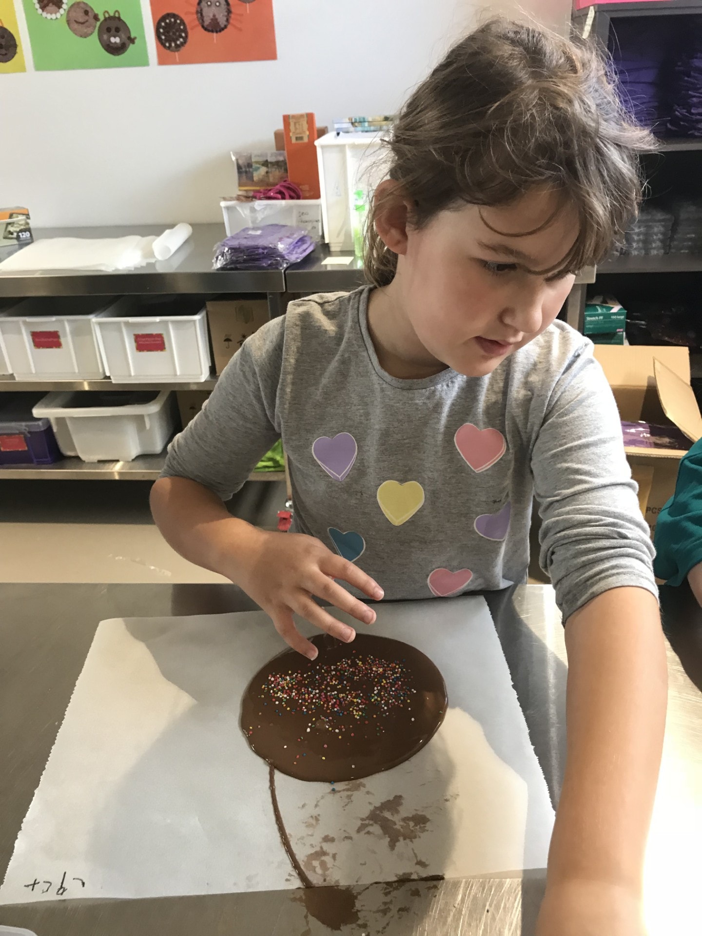 A young person enjoying a chocolate-making activity — building skills and confidence